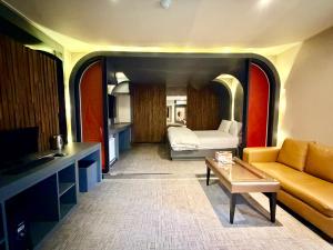 a living room with a bed and a couch and a table at 로미오앤줄리엣 in Daegu