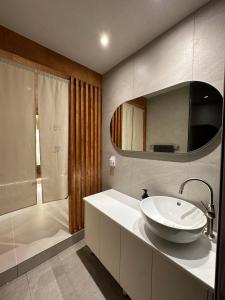 a bathroom with a white sink and a shower at 광안해옥 in Kwangan-dong