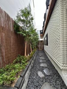 a walkway next to a building with a tree at 광안해옥 in Kwangan-dong
