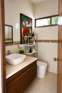 a bathroom with a sink and a toilet at Casa Mayi Private house with pool in Chablekal in Chablekal