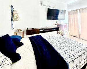 a bedroom with a bed with blue and white sheets at Casa Mayi Private house with pool in Chablekal in Chablekal +3 photos