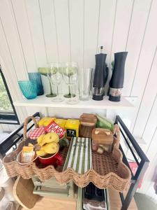 a table with food and wine glasses on a shelf at Secret Garden by Tiny Away in Uki
