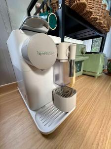 a kitchenaid mixer sitting on top of a wooden floor at Secret Garden by Tiny Away in Uki