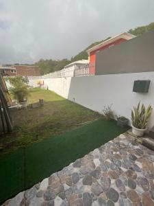 a garden with a stone walkway next to a building at Domaine Maud-Jardin de Maud ! 100m plage in Saint-Pierre