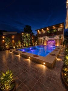 a swimming pool with lights in a courtyard at night at San Franz Hotel La Perla in San Francisco