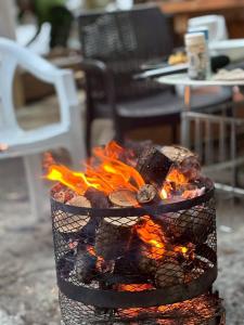 a fire pit with flames in a yard at ペルセウス座流星群の体験 Villa Dottaru 土樽の自然に囲まれた大人の秘密基地 in Yuzawa +42 photos
