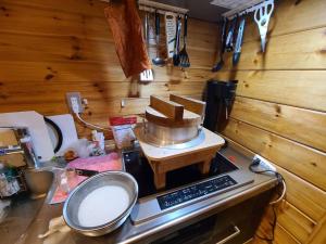 a kitchen with a counter top with a mixer on a stove at ペルセウス座流星群の体験 Villa Dottaru 土樽の自然に囲まれた大人の秘密基地 in Yuzawa