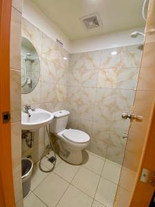 a bathroom with a toilet and a sink at The P Residences in San Agustin
