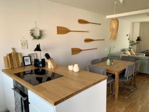 a kitchen with a counter top and a dining room at Heilige-Hafen-Lodge in Heiligenhafen