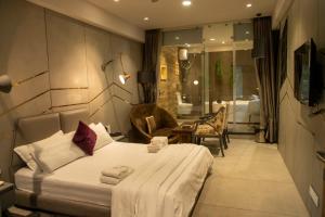 a hotel room with a bed and a bathroom at Hotel Welcome Palace in Surat