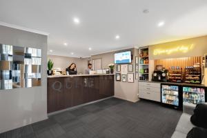 a lobby of a coffee shop with two people at a counter at Quest Mont Albert in Box Hill