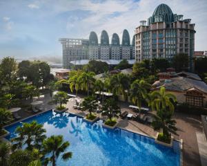 an aerial view of a resort with a large swimming pool at Resorts World Sentosa - Hotel Ora in Singapore