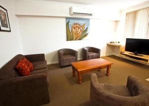 a living room with a couch and chairs and a table at Hibernian Hotel in Beechworth +1 photo
