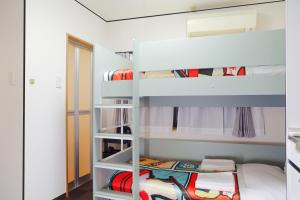 a bedroom with bunk beds and a bunk bed at Namba 5min by subway OYASUMI Manga HOTEL 24 hours Self-check-in Japanese-Style hotel in Osaka