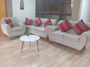 a living room with two couches and a table at Hospedaje San Isidro in Cali