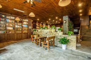 a dining room with a table and a brick wall at Zhangjiajie Cloudscape Courtyard Hotel-Vegan Available, Chinese Retro Style,Tea Culture Experience, Free Breakfast ,Travel Guide& Book Tickets,Friendly Host,Orient esthetics in Hanqiyu