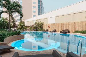 a swimming pool in the middle of a building at Centara Udon in Udon Thani
