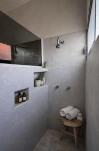 a bathroom with a shower with a bench in it at Casa Cedro Y Olivo in Gutiérrez Zamora