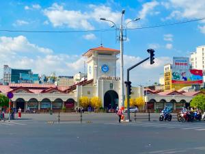 a building with a clock tower in the middle of a street at Pink Horizon Saigon Airport Hotel in Ho Chi Minh City