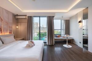 a hotel room with a bed and a view of a city at Bayphere Residence Private Beach With Fitness and Pool in Na Jomtien +211 photos