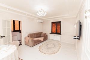 a living room with a couch and a table at Miracle Apartment in Samarkand