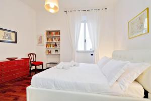 a white bedroom with a white bed and a red dresser at RomeAsYouLike-Monti Experience 295 in Rome