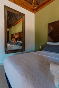 a bedroom with two beds and a mirror at Alma de Zorro in Bacalar +43 photos