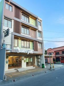 a building with a sign on the side of it at Olive's Suites in Kalibo