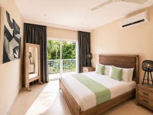 a bedroom with a bed and a large window at Special offer! Villa Bueno with private pool&beach in Punta Cana