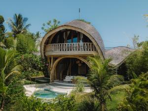 a resort with a pool and a house at Mandala Eco Resort Lombok in Selong Belanak