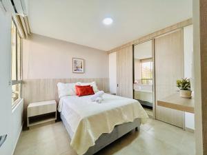 a small bedroom with a bed and a window at Capriela Serena del Mar in Cartagena de Indias +18 photos
