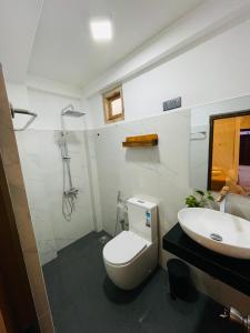 a bathroom with a toilet and a sink at Ella Solara Heaven in Ella +16 photos