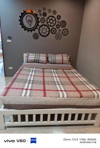 a bed in a bedroom with avertisement for at Splash Paradise Villa in Cha Am +16 photos