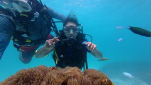 a diver taking a picture of a reef at Blu Laguna Beach Homestay, Agatti Island, Lakshadweep - Only For Indian Nationals with valid entry permit in Agatti