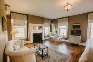 a living room with a couch and a fireplace at The Inn at Ragged Edge in Chambersburg