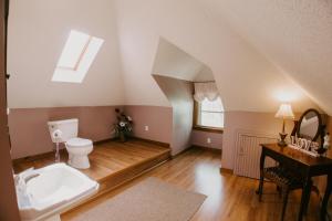 an attic bathroom with a toilet and a sink at The Inn at Ragged Edge in Chambersburg +45 photos