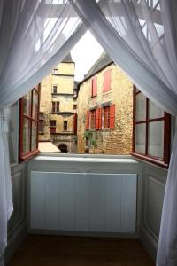 a room with a window with a view of a building at Le Royere in Sarlat-la-Canéda