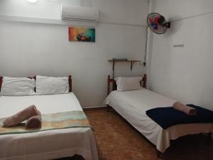 two beds sitting next to each other in a room at Green Peak Stay in Port Louis