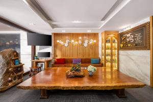 a living room with a table and a couch at White Sand Boutique Hotel in Danang