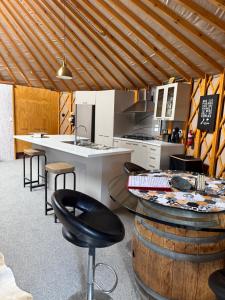 a kitchen with a counter and a table and chairs at Riverview Yurt in Tarras
