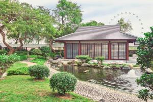 a pavilion with a pond in a garden at Pan Pacific Singapore in Singapore