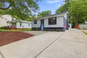 a white house with a driveway at Irie Vibes Private Guest House Downtown in Raleigh