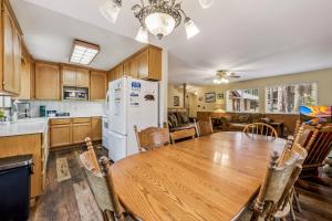 a kitchen with a wooden table and a white refrigerator at 838 Placer Avenue home in South Lake Tahoe