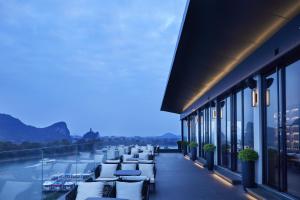 a balcony of a building with a view of a harbor at GUILIN LI RIVER CIAO Hotel in Guilin