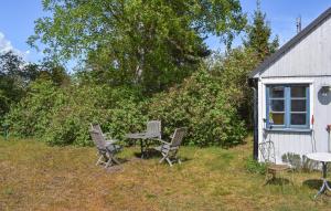 a table and chairs in a yard next to a building at Stunning Home In Borrby in Borrby