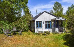 a small shed with a table and chairs in the yard at Stunning Home In Borrby in Borrby