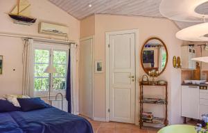 a bedroom with a bed and a mirror at Stunning Home In Borrby in Borrby