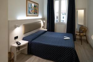 a bedroom with a blue bed and a window at Alloggi Liviana Pontecorvo in Padova