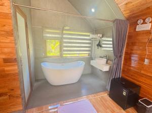 a large bathroom with a tub and a window at Green Valley Retreat in Phong Nha +29 photos