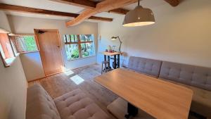 a living room with a couch and a table at Loving Garden Stayラビングガーデンステイ in Mima
